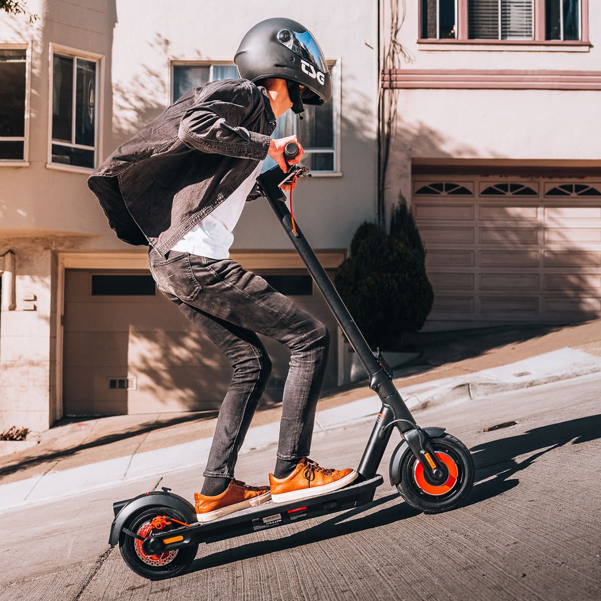 Rider using INMOTION Climber scooter on steep hill, showcasing performance.