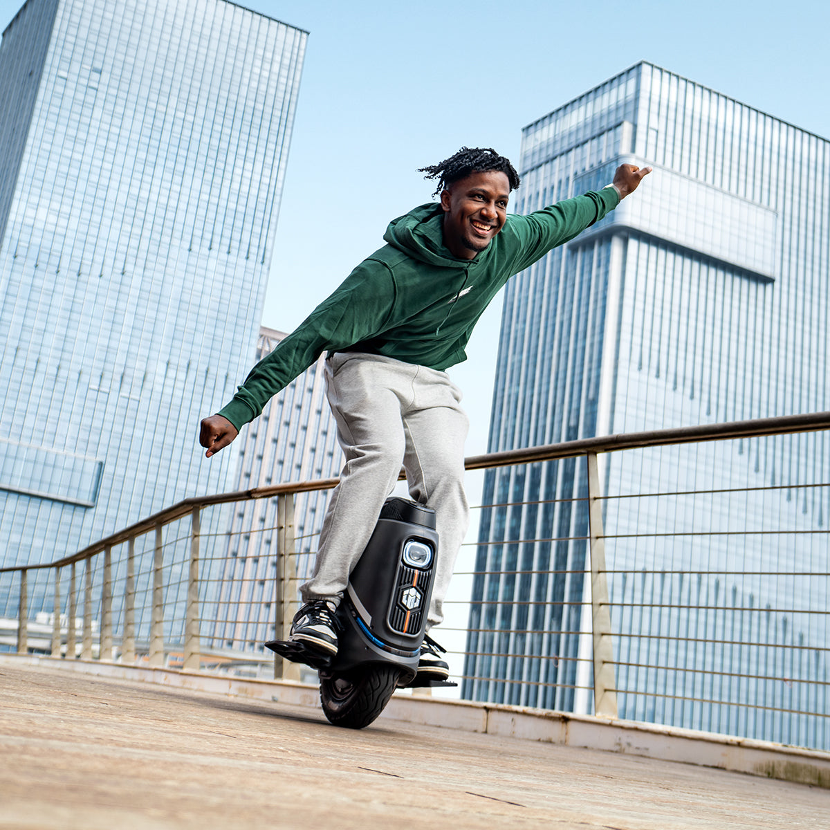 A man rides an INMOTION V9 electric unicycle(EUC) in a cityscape.