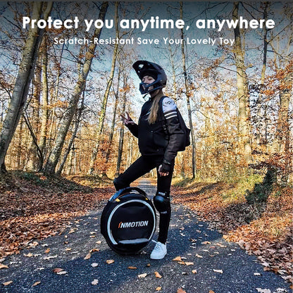 Person in protective gear standing next to a black unicycle cover in a forest.