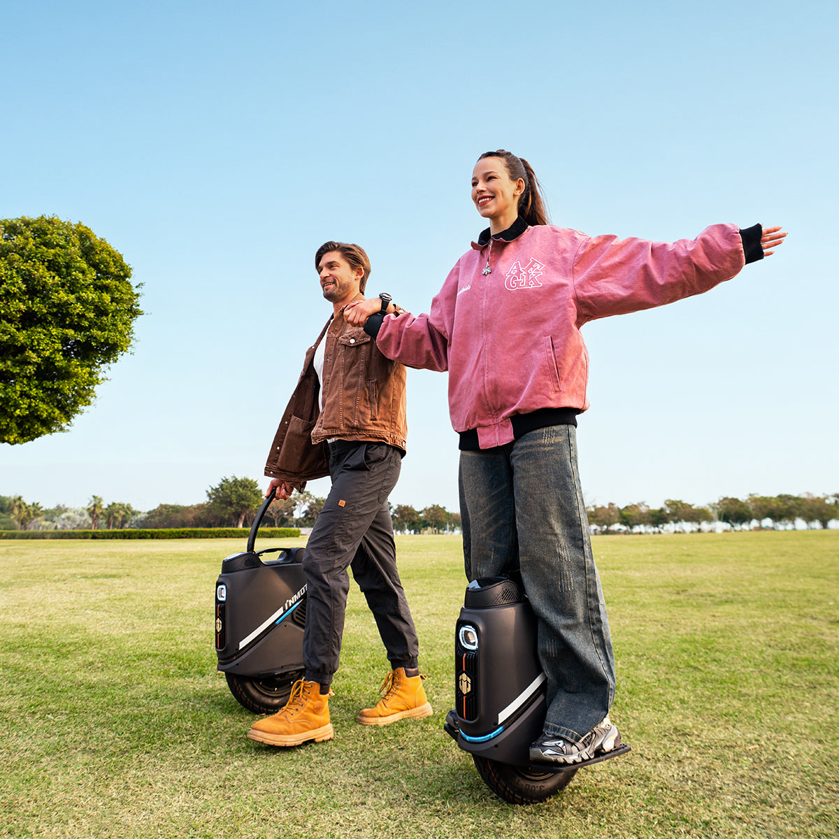 Couple enjoying a ride on INMOTION V9 electric unicycles(EUC) in a park.