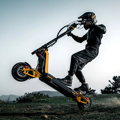 Rider doing a wheelie on INMOTION RS electric scooter in outdoor terrain