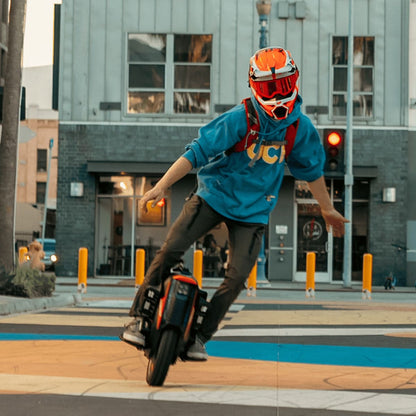 Rider demonstrating the INMOTION V12 Pro unicycle in action.