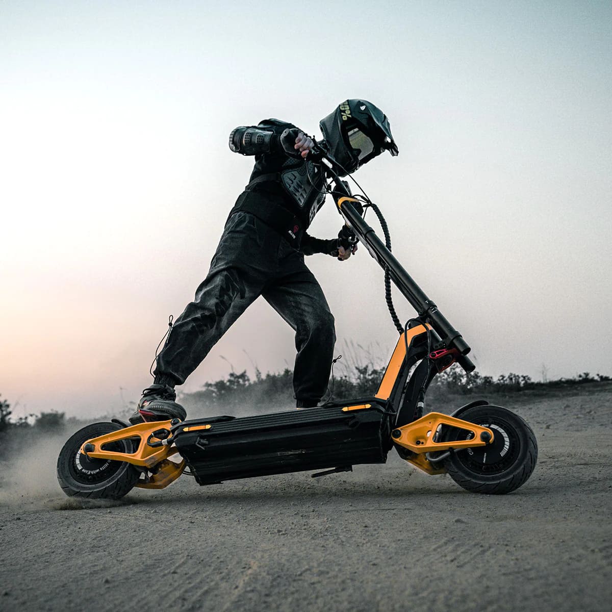 Rider performing a stunt on INMOTION RS electric scooter in rugged terrain