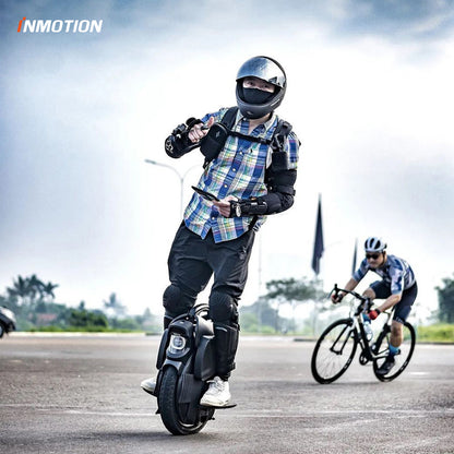 Rider demonstrating INMOTION V11 unicycle with foam leg pads in action.