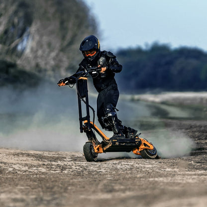 Rider performing a stunt on INMOTION RS electric scooter on rugged terrain.